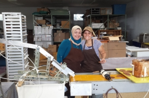 Suha, left, a refugee from Iraq, helps to make Stroopies with The Stroopie Co. co-owner Jennie Groff.